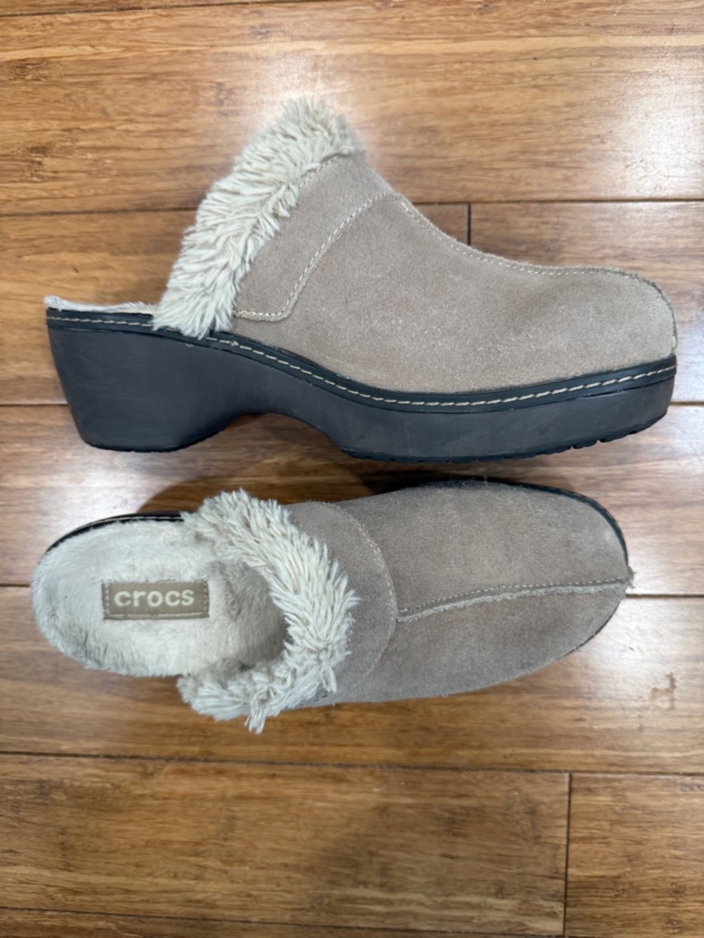 Crocs slip-on mules featuring a faux fur lining and platform sole.